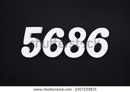 Black for the background. The number 5686 is made of white painted wood.