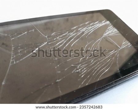 closeup photo of smartphone with cracked screen isolated on white, damaged