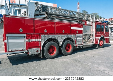 A fire truck with a retractable ladder for extinguishing fires at a height. A fire truck for the delivery of firefighters to the place of fire and the supply of extinguishing agent for extinguishing. Royalty-Free Stock Photo #2357242883