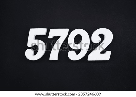 Black for the background. The number 5792 is made of white painted wood.
