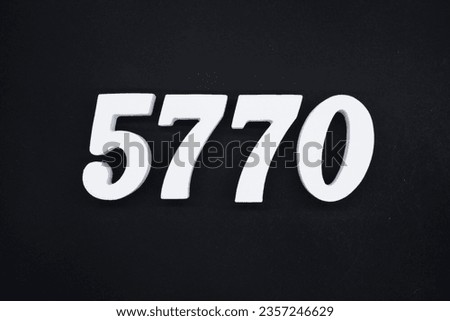 Black for the background. The number 5770 is made of white painted wood.