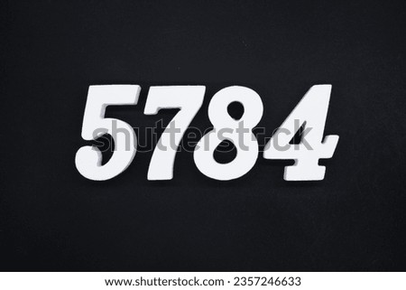 Black for the background. The number 5784 is made of white painted wood.