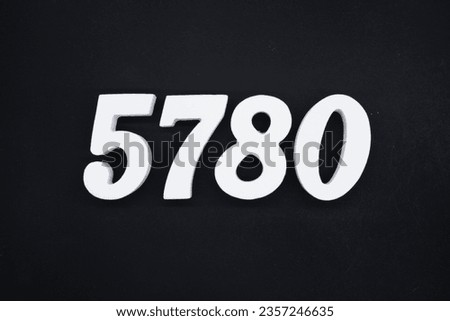 Black for the background. The number 5780 is made of white painted wood.