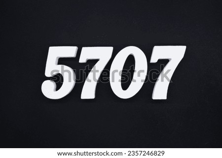 Black for the background. The number 5707 is made of white painted wood.