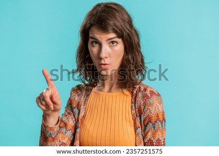 Displeased upset Caucasian woman reacting to unpleasant awful idea, dissatisfied with bad quality, wave hand, shake head No, dismiss idea, dont like proposal. Girl isolated on blue studio background Royalty-Free Stock Photo #2357251575