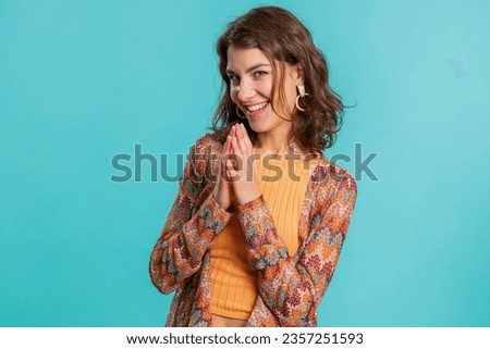 Sneaky cunning young Caucasian woman with tricky face gesticulating and scheming evil plan, thinking over devious villain idea, cunning cheats, jokes, pranks. Girl isolated on blue studio background Royalty-Free Stock Photo #2357251593