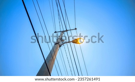 Street lights that start to come on just before sunset, industrial Royalty-Free Stock Photo #2357261491