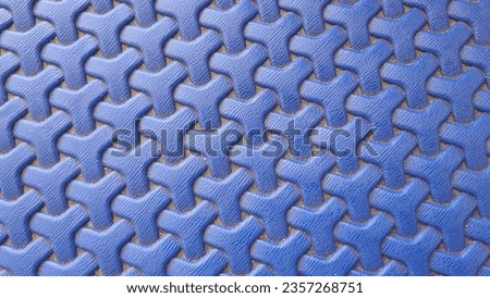 Plastic weave pattern background. Zigzag interlocking of symmetrical shapes. Blue woven background.