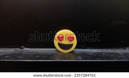 yellow and red-eyed cheerful emoticon on black background