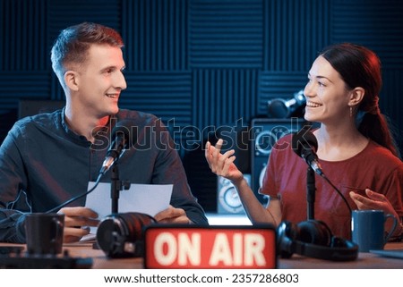 Young radio host interviewing a guest during a radio show Royalty-Free Stock Photo #2357286803