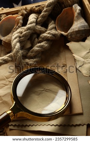 Columbus Day. Magnifying glass with rope and old letters
