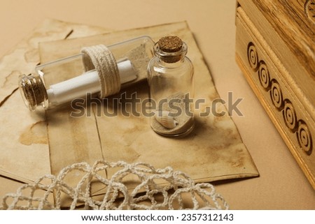 Columbus Day. Old envelopes and a glass bottle with a letter inside