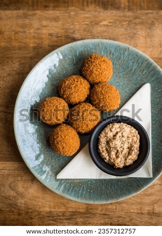 Top view of traditional Dutch bitterballen with mustard on a plate on a wooden table Royalty-Free Stock Photo #2357312757