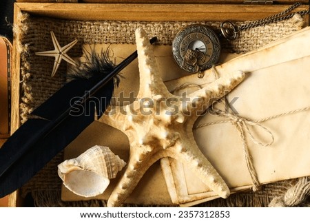 Columbus Day. A starfish with a stack of old letters