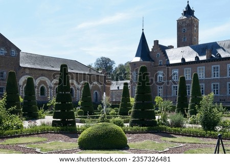 Modern french garden with the Alden Biesen Castle in the background, Limburg, Belgium. Royalty-Free Stock Photo #2357326481