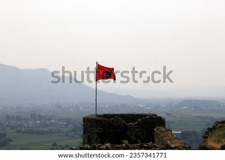 Albania national flag waving on the tower of the old Shkodra fortress, Rozafa Castle