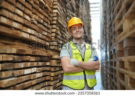 Worker are working at lumber yard in Large Warehouse. Worker are  working
on woodworking machine, lumber and Inventory check at Storage shelves in lumberyard. Royalty-Free Stock Photo #2357358361