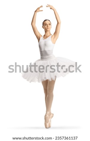Full length profile shot of a ballerina in a white tutu dress dancing with arms up isolated on white background