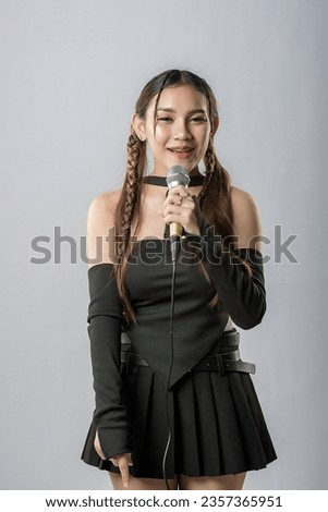 Happy young singer recording music sound through microphone in studio isolated on white background