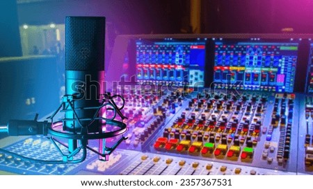 Professional microphone. DJ mixing console. Sound recording equipment. Condenser microphone on tripod. Podcast recording equipment. Audio technologies. DJ workplace. Selective focus