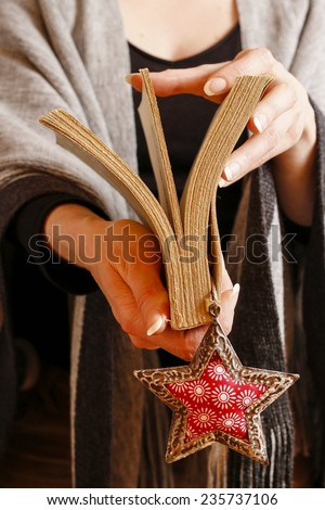 Woman holding book with bookmark in star shape