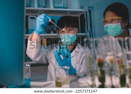 scientist dripping substances of ecological skin care beauty products in night lab development concept Research with plants and scientific extraction in glassware