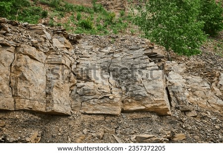 Layers of soil with groundwater. Details of earth layers in a clay pit. Form and colors of soil. Background natural textures. Ground land cross section. Abstract terrain view. Cracked dry rural ground Royalty-Free Stock Photo #2357372205