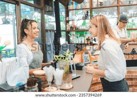 Happy smile waitress standing at restaurant, Young professional business woman attend new customers in her coffee shop, Business owner cheerful successful to welcome, Selling eatery to cafes customers Royalty-Free Stock Photo #2357394269