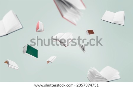 Many flying books on light background Royalty-Free Stock Photo #2357394731