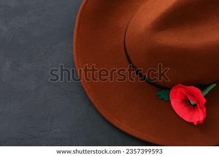 Poppy flower and hat on black background. Remembrance Day in Canada