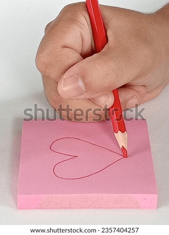 Draw a heart in pink paper on a white background.