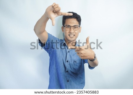 handsome business man over white isolated background smiling making frame with hands and fingers with happy face. Creativity and photography concept.