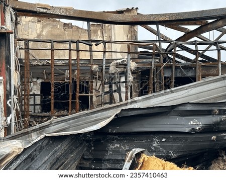 Remains of a metal structure after a fire. Royalty-Free Stock Photo #2357410463