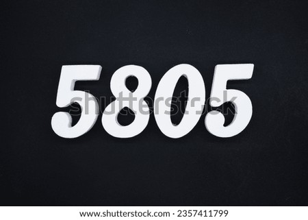 Black for the background. The number 5805 is made of white painted wood.