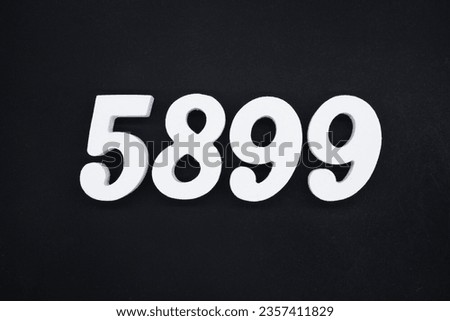 Black for the background. The number 5899 is made of white painted wood.