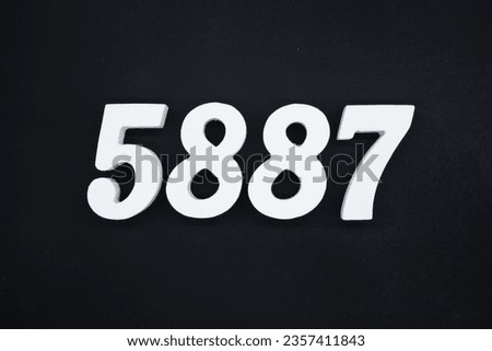 Black for the background. The number 5887 is made of white painted wood.