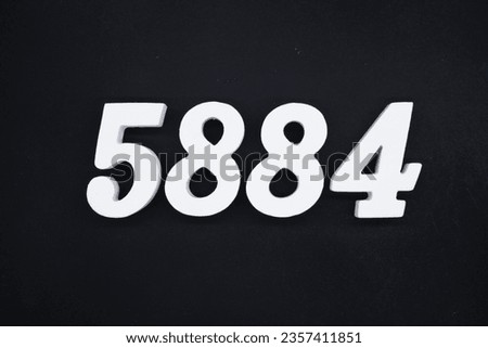 Black for the background. The number 5884 is made of white painted wood.