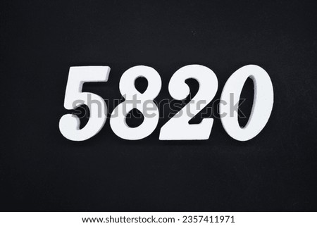Black for the background. The number 5820 is made of white painted wood.