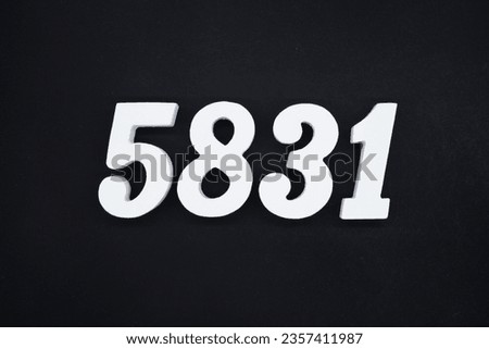 Black for the background. The number 5831 is made of white painted wood.