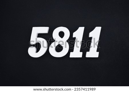 Black for the background. The number 5811 is made of white painted wood.