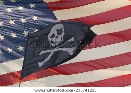 waving pirate flag jolly roger on american star and stripes