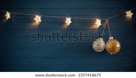 Christmas lights on blue wooden background