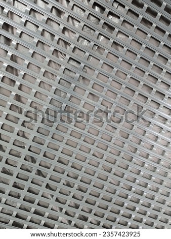 Metal grid. Perforated blinds for doorways. Perforated metal security shutters