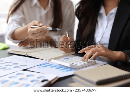 Businesswoman meeting to discuss chart analysis in financial report and budget planning in accounting.