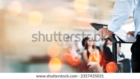 Podium, business and presentation, speaker and audience, conference and banner with mockup space. Corporate training, people at seminar and communication, leadership and public speaking with bokeh Royalty-Free Stock Photo #2357435031