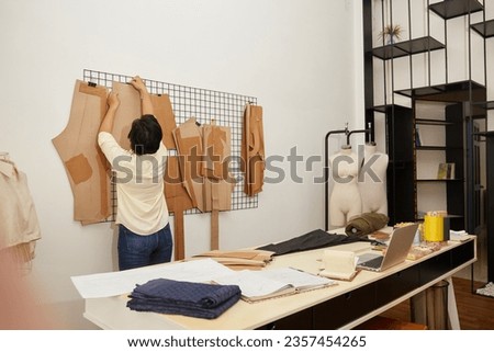 Asian Professional Female Tailor Working At Workshop
