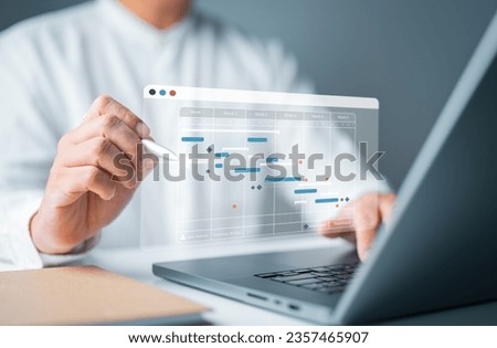 Manager working with Gantt chart schedule for plan tasks and progress. Corporate strategy for construction, operations, sales, to-do list, and marketing. Project management planning software concept.  Royalty-Free Stock Photo #2357465907