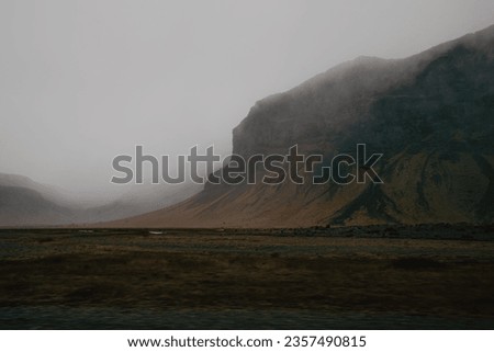 icelandic moody landscape on a rainy day mountains loom in the distance