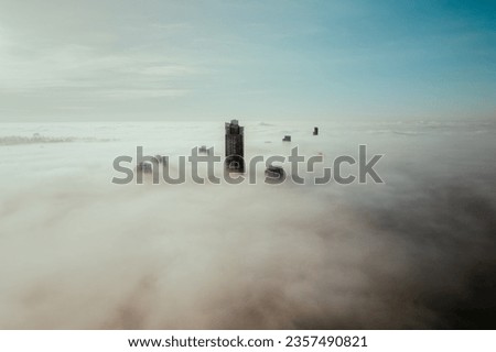 above the clouds and fog during sunrise in the city