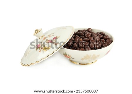 Porcelain box with chocolate dragee isolated on a white background. German vintage porcelain. Royalty-Free Stock Photo #2357500037